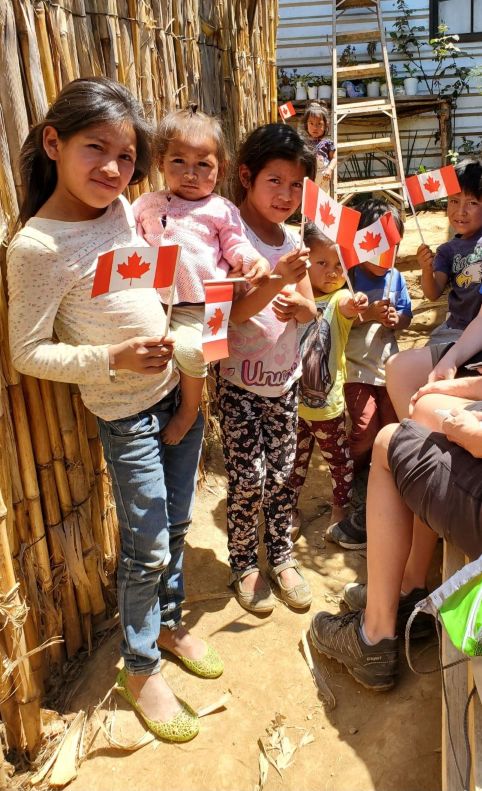 Guatemalan children holding hand held Canadian flags
